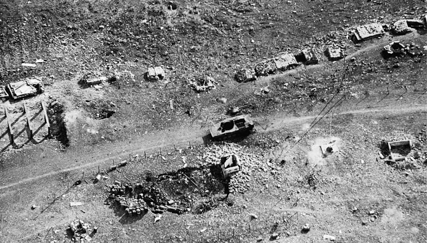 Photo of Detachment A-101 operations bunker after the 7 February 1968 battle. Note the one PT-76 tank left behind, the rock-filled 55-gallon barrels (LAW firing positions left of the bunker crater, and the remnants of the ops bunker tower on right corner. After the Americans escaped NVA engineers filled the bunker with explosives and detonated them; hence the large crater.