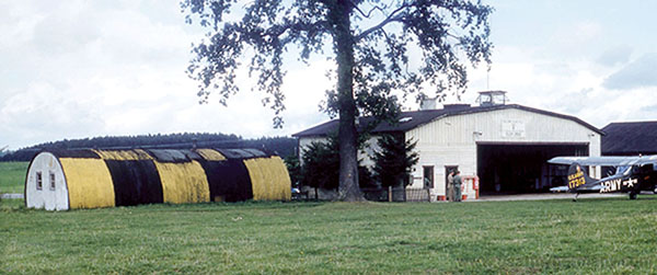 Bad Tölz Army Airfield hangar before the Control Tower was built. An O-1  Bird Dog is parked outside