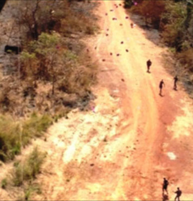 Military-aged males in an LRA-affected area arrive on the scene after a leaflet drop hits the target.