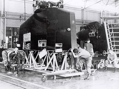 The rear pylon after being removed from one of the MH-47Ds. The maintenance crew is placing it on a specially-constructed cradle that will accompany the helicopter onto the C-50.