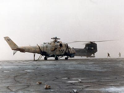 The Hind with MAJ Hasselbach&rsquo;s Chinook just as the sand storm is about to engulf them. The Chinook&rsquo;s rotor blades are still turning as the crews could not shut the engines off for fear that the wind might bend the blades into the airframe.