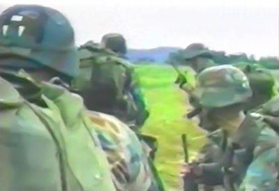 U.S. Marines engaged with enemy forces at La Chorrera allow U.S. Army PSYOP soldiers to make surrender appeals via a tactical loudspeaker.