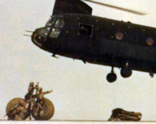 528th Special Operations Support Battalion soldiers near Dammam, Saudi Arabia, prepare to sling-load 500-gallon water blivets under a CH-47 helicopter, for transport to forward-located Special Operations Forces locations.