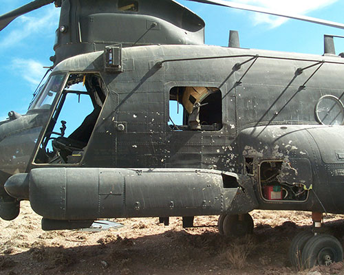 A close up view of the damage to the front of 476. The RPG had exploded on the outside of the helicopter, and started a fire that affected the electrical system.