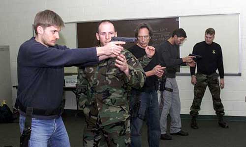 Coster-Waldau, Fichtner, and Bana conduct dry fire exercises.