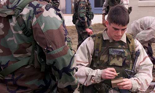 Hartnett loads blank rounds into a magazine during MOUT training.