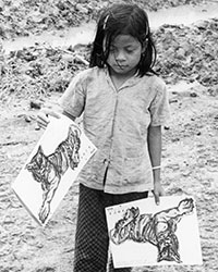A young girl holding copies of &lsquo;Year of the Tiger&rsquo; Giap Dan (1974) calendar/notebook