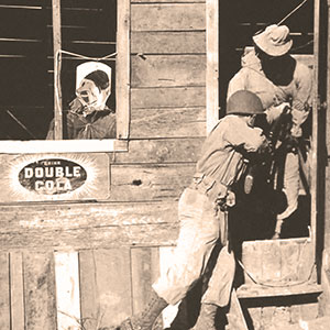 SGT Joe Perna (Ranger student) bayonets a dummy as part of the &lsquo;mopping up&rsquo; of &lsquo;Naziville.&rsquo; Note the caricature of Adolf Hitler in the window.