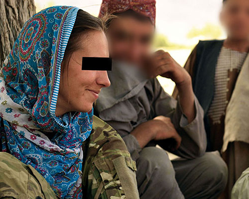 A CST-3 member supporting VSO for Special Operations Task Force-South (SOTF-S) talks with Afghan children.