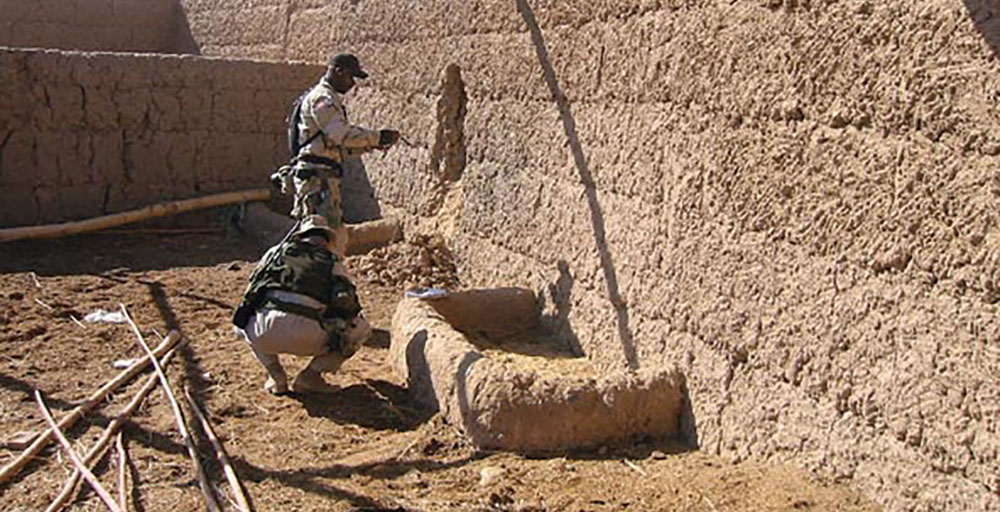 Soldiers from ODA 513 practice breaching compound walls with live explosive charges at a demolition range near Kandahar, Afghanistan.