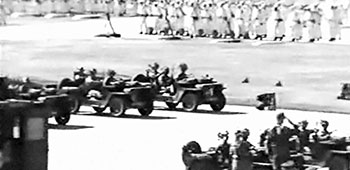 Vehicular elements of the 82nd and 101st Airborne Divisions passed by the reviewing stand to conclude the presentation of troops. In the background is an airborne infantry battalion wearing winter overwhites and carrying winter gear.