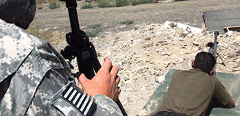 A 1st SFG soldier observes his Indian Army PARA (SF) counterpart during long‐range marksmanship training at Yakima Training Center.