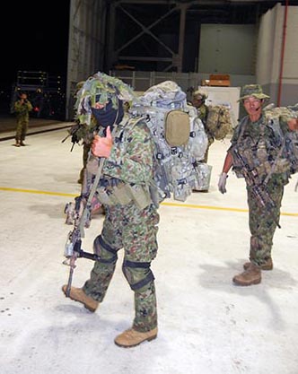 One of the SFGp Team Members prepares to board the CH-47 that will infiltrate them at Bellows Feld.