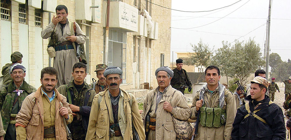 The rough and ready Peshmerga forces proved to be a reliable ally for the coalition. In the background, captured Iraqi troops are rounded up.