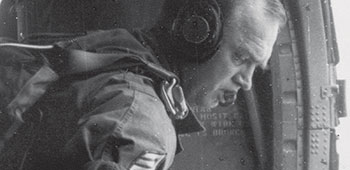 SFC Spencer Gay jumpmastering a U.S. Army H-21 Chickasaw helicopter