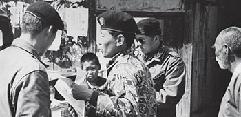 ROKA Special Forces pass out Psywar products during MEDCAP with SFDK.