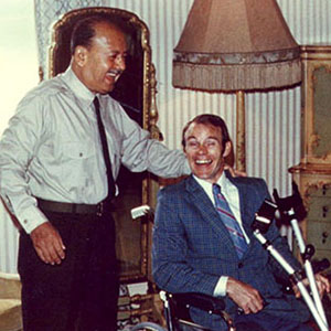 Jim Cloud in the president&rsquo;s wheelchair with General Velasco Alvarado after he walked without crutches wearing his new Cloud-built leg.