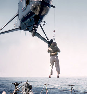 U.S. Navy RH-5 Sikorsky helicopter effecting pilot rescue with sling and &ldquo;horse collar.&rdquo;