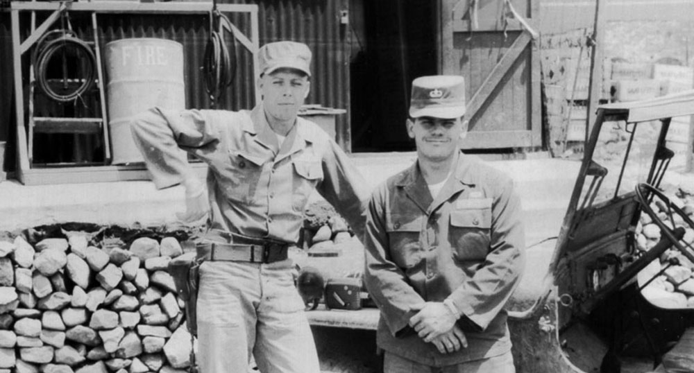 Corporal Oscar &ldquo;Pete&rdquo; Johnson, JACK parachute rigger, with Sergeant Tom Fosmire collecting supplies from the British post exchange at Pusan before shipping out on K-333.
