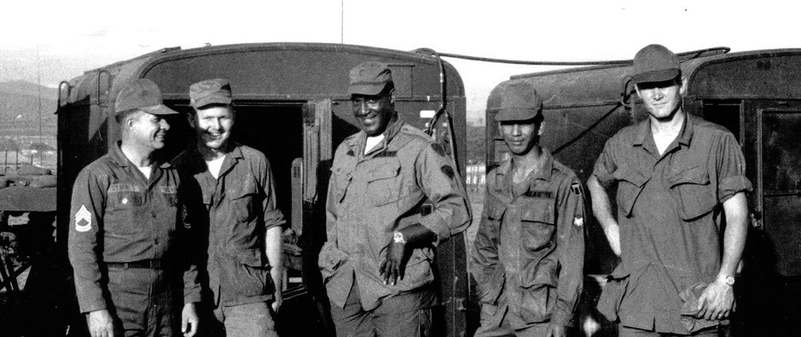 Soldiers of the 7th PSYOP Group take a break while building the site. Civilian radio technician Bill Hamby is at the right.