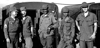 Soldiers of the 7th PSYOP Group take a break while building the site. Civilian radio technician Bill Hamby is at the right.