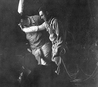 John Beamish of “A” Group stands in the door of the C-87 drop aircraft as Lieutenant Colonel John Coughlin, Detachment 101’s Executive Officer, looks out.