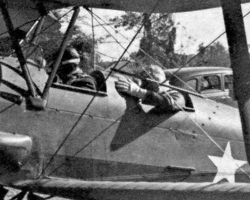 The de Havilland Gypsy Moth in which Lieutenant Colonel Eifler flew General Donovan behind Japanese lines to visit the KNOTHEAD group. In the rear and at the controls of the airplane is Lieutenant Colonel Carl Eifler, commanding officer of Detachment 101. General William J. Donovan is in the front seat.
