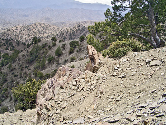 Top of the rocky abutment. Reilly is wounded while seeking cover to left of pointed rocks in the center.
