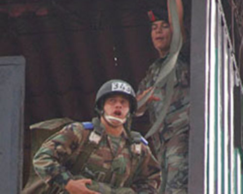 A Colombian paratrooper in training takes his turn jumping from the 34-foot tower.