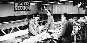 Men of the Rigger Section pack parachutes.