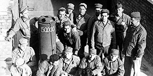 Area H personnel pose with the 50,000th canister packed.