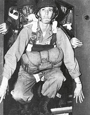 Lieutenant Richard Mascuch demonstrates how small the CG-4A glider door was. Jumpers had to avoid hitting themselves on the head or catching their backpacks on the top of the door.