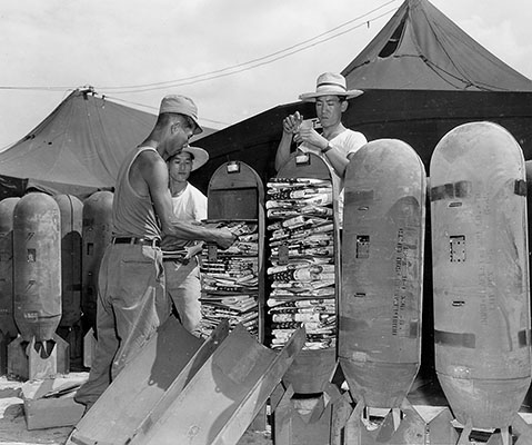 Korean workers load newspaper leaflets into bombs (September 1952)