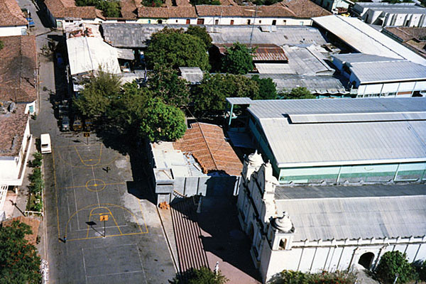 The old DM-4 cuartel in San Francisco de Gotera &ldquo;butted up&rdquo; against the Catholic church in the town center. Note the basketball court painted on the street outside the main gate.