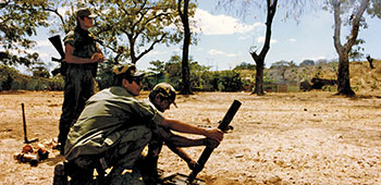 Sergeant First Class LeRoy Sena demonstrates how to &ldquo;direct lay&rdquo; a 60mm mortar to the Salvadoran Cazadores.