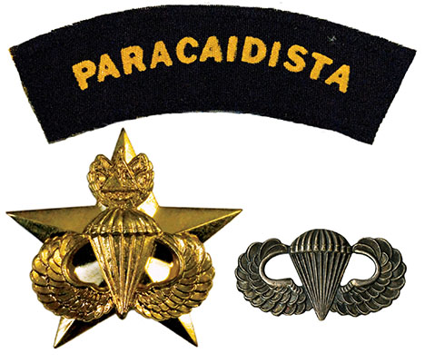 The original solid brass El Salvadoran parachute, worn above the left breast uniform pocket and then on a black beret, was about one and half times larger than the US Army parachute badge.