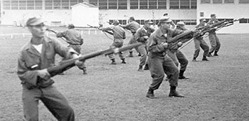 Salvadoran Ranger students practice bayonet drills using M-1 Garand rifles with fixed, sheathed bayonets.