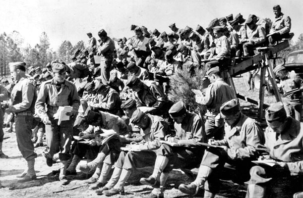 OCS Candidates taking written tests in the field at Fort Benning.