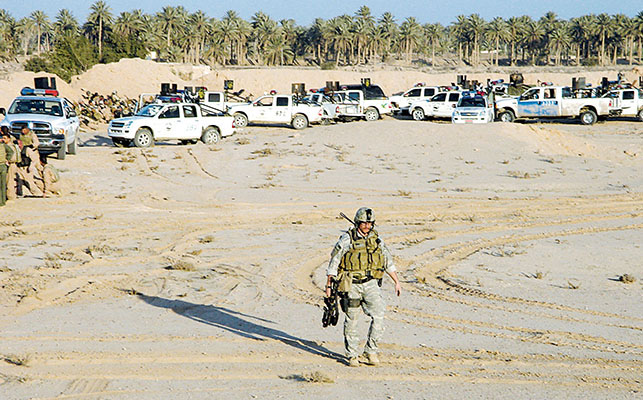 Hilla SWAT trucks spread along the southern base of the walled compound.