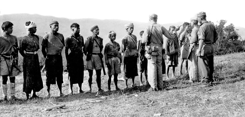 A Detachment 101 officer and his Kachin junior officers instruct new recruits, Burma, 1944.