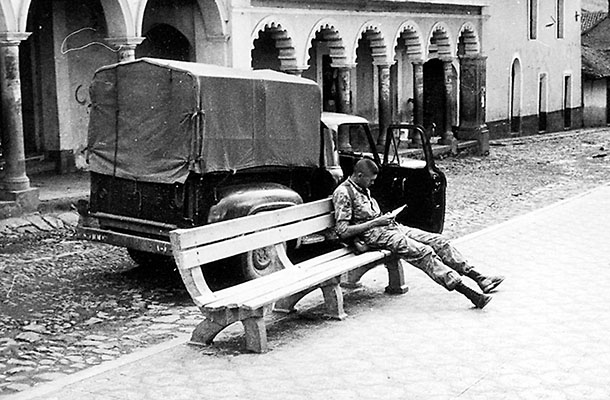 MSG Gustavo Fabian studies the map in a small town while MAJ Waghelstein and Bolivian Sergeant Mars ask questions of the locals.