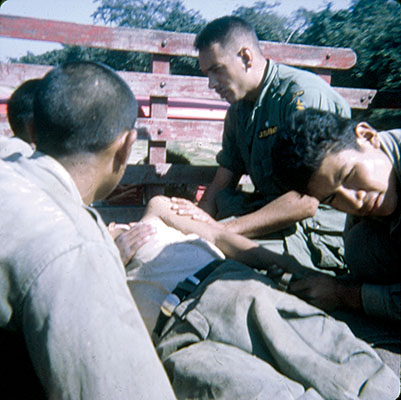 SSG Jerald L. Peterson attending one of the casualties of the mortar accident.