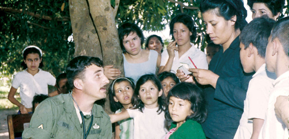 Since one SF medic had to be present in camp on radio standby while marksmanship, live fire exercises, and field training were being conducted, SFC Robert Owens (who replaced SSG Jerald Peterson 3 October 1967) and SSG James Hapka rotated the MEDCAP missions. Here Hapka explains to a mother what must be done to cure her daughter&rsquo;s problem.