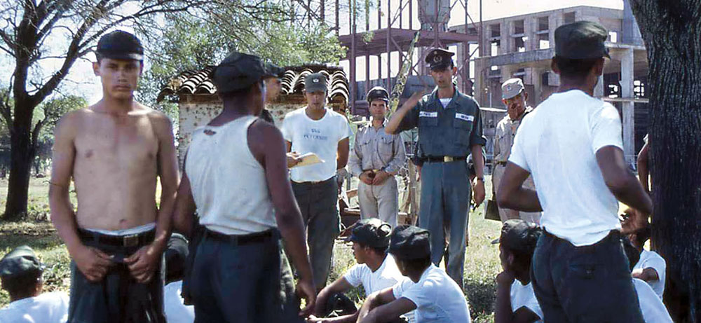 SSGs James Hapka (left) and Jerald L. Peterson (center) gave these Bolivian soldiers their first physical exams.