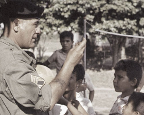 SFC Roland J. Milliard passes out candy during a MEDCAP
