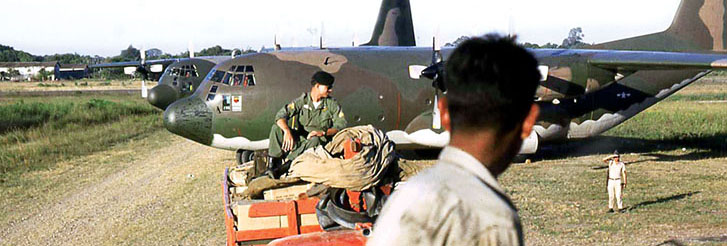 Departing Santa Cruz airport with the trucks crammed with equipment and supplies. The two C-130s are in the background.