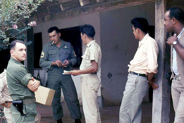 1LT Harvey W. Wallender (left) replaced CPT Margarito Cruz in October 1967. Here SFC Daniel Chapa and he talk with the &ldquo;agents.&rdquo;