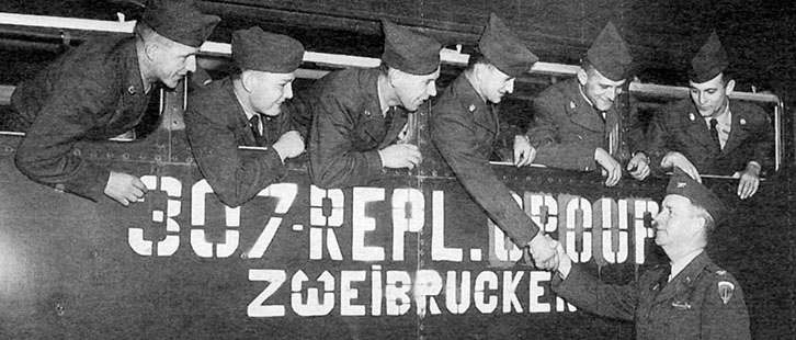 Private Henryk Szarek shakes hands with the 307th Replacement Group (EUCOM) commander before leaving Zweibrucken with five other Lodge Act enlistees for Camp Grohn in Bremen.