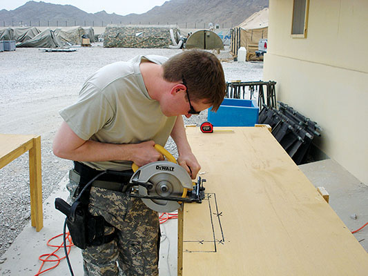 Specialist Ronnie M. Heflin built shelves for the medical supply room at the hospital.