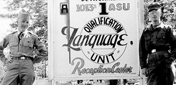 Vaclav Hradecky and a Lodge Act buddy pose by the Detachment 1, 1013th ASU Language Qualification sign at Fort Devens.